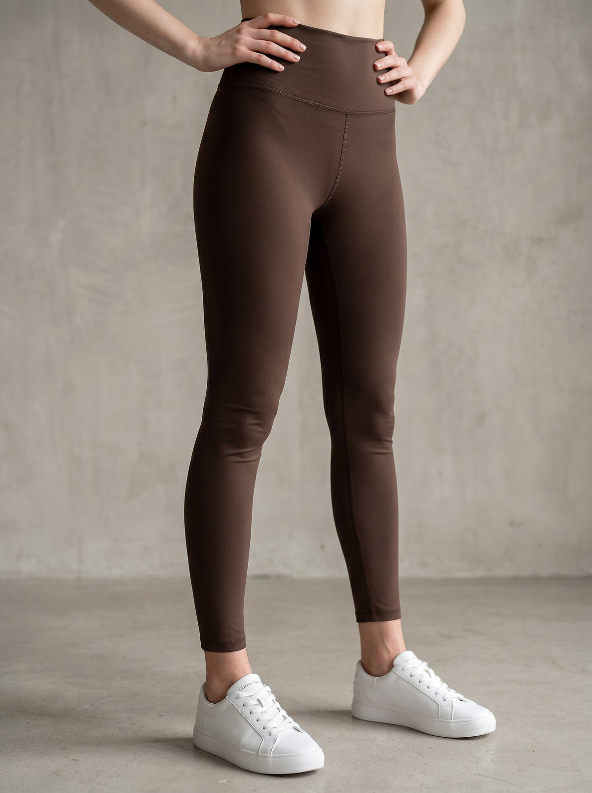 MONROE STORE dark brown high-waisted skinny yoga leggings with a V-shaped seam on the back.